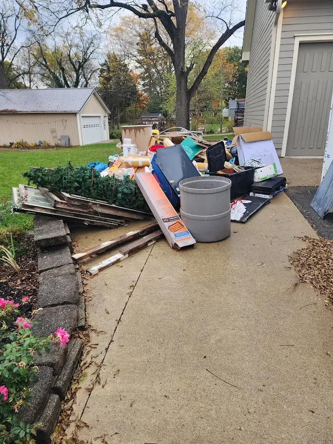 Dumpster being loaded with debris for Roofing Dumpster Rental in Waterloo
